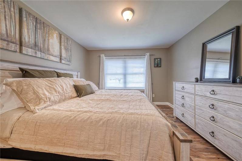 Lovely primary bedroom with large window, upgraded full bathroom with linen closet, and walk-in closet.