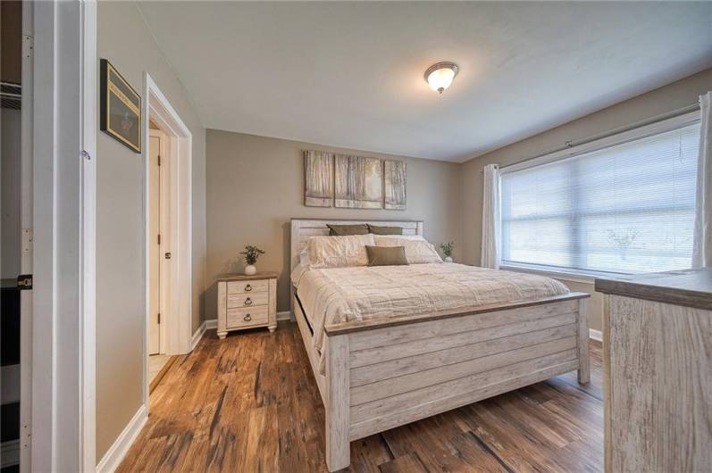 Lovely primary bedroom with large window, upgraded full bathroom with linen closet, and walk-in closet.