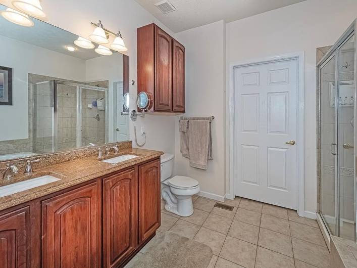 Double sink, closet, shower stall and garden tub.