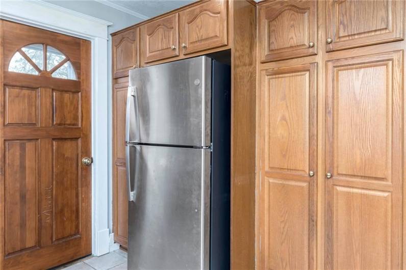 A pantry, stainless refrigerator and additional storage complete the kitchen.