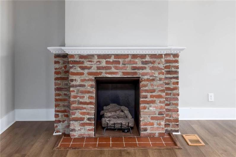 The original brickwork of the fireplace adds so much old world charm to this updated home.