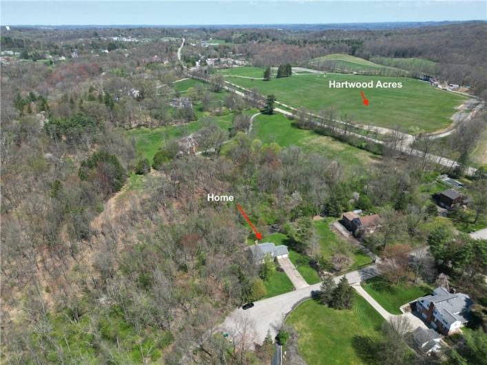 This property boasts an ideal location, situated on a cul-de-sac adjacent to woods and within walking distance of Hartwood Acres.