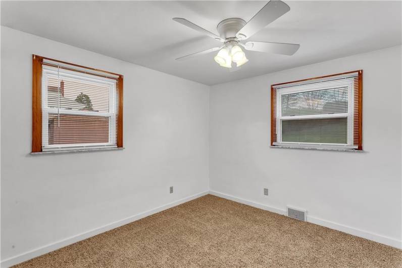 Main Bedroom on Back of the Home with Ceiling Fan, 2 Windows with Blinds.