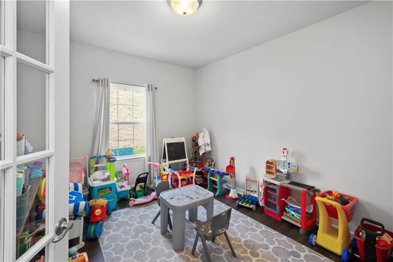 Currently used as a playroom, this wonderful home office will make your work from home day better!