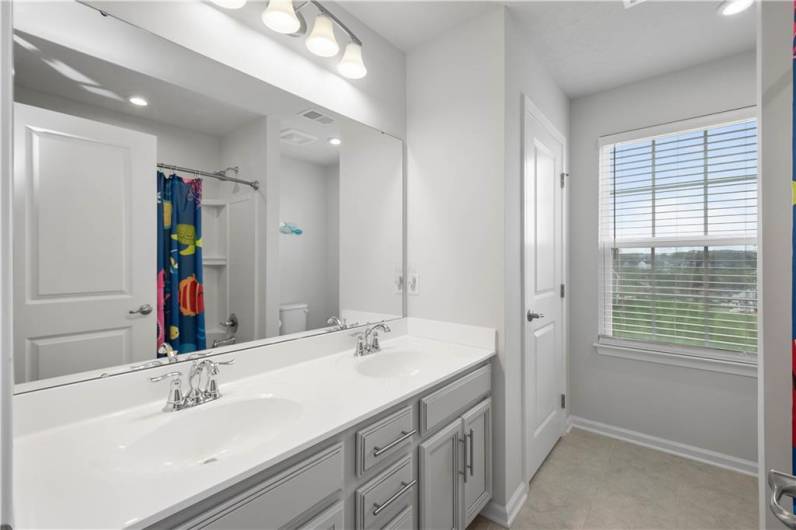 2nd floor shared hall bathroom with a double vanity, and linen closet.