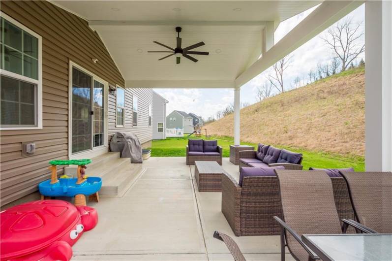 Covered patio added to this home provides space to relax, grill and dine al fresco.
