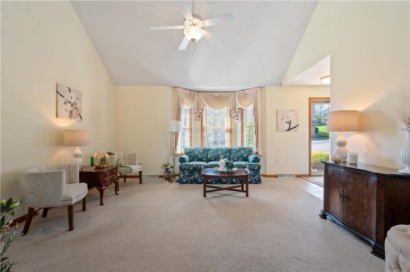 The spacious living room includes a large bay window that offers plenty of natural light.
