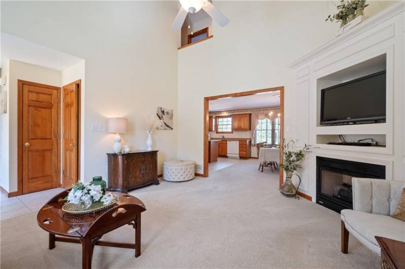 The living room offers a corner gas fireplace with built-in entertainment unit.