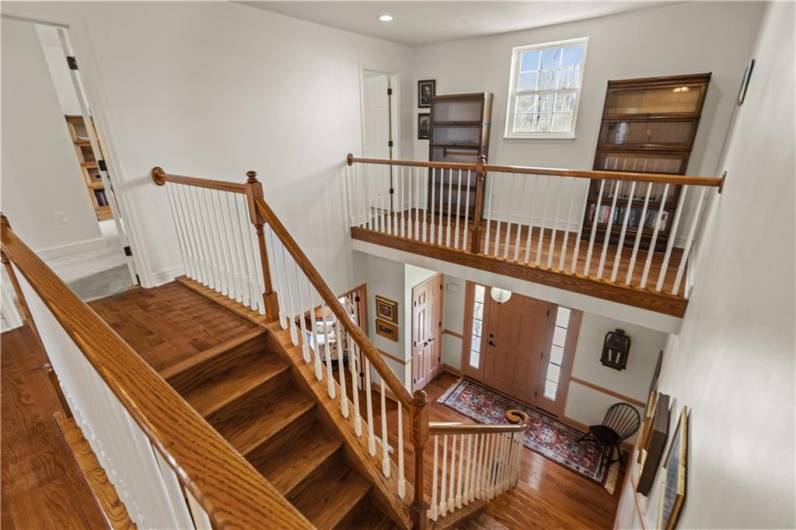 View of the entry from the upper level. The hardwood floors and wood molding continue upstairs.