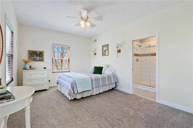 The main level master bedroom features neutral carpet and an en suite full bath.