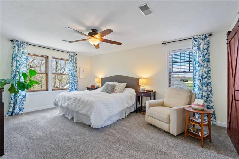 The upper level master bedroom features neutral decor, a huge walk-in closet, and spa-like master bath.