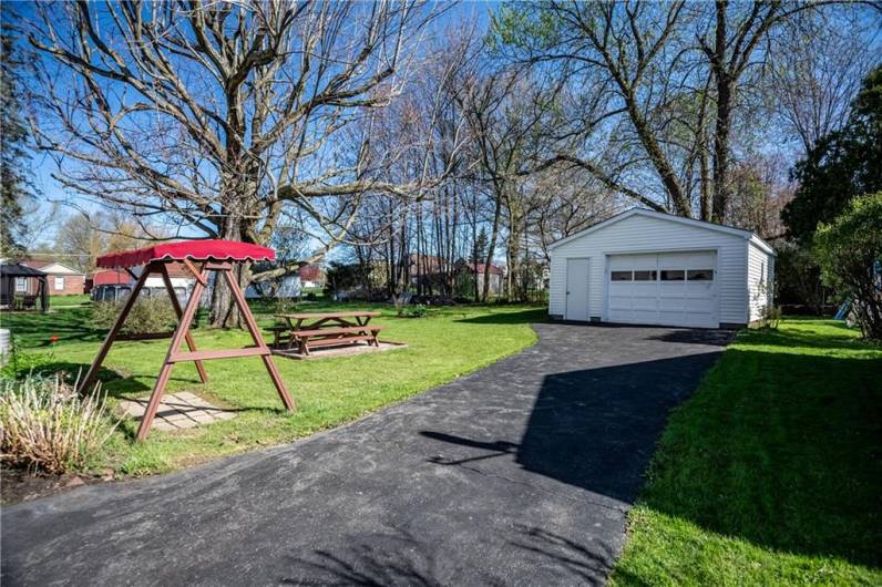 Quaint backyard with detached garage. Picnic table stays to enjoy evening meals!