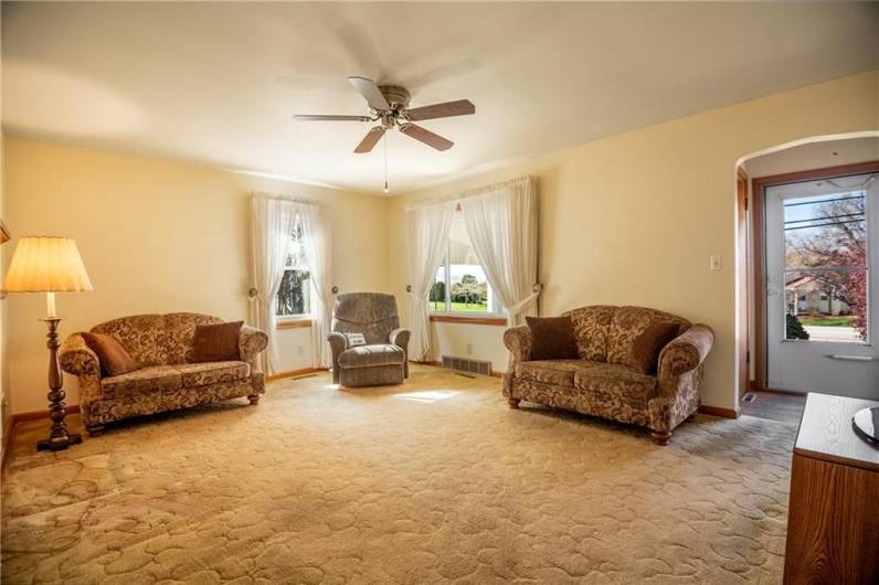 Living room off of the front entrance, hardwood floors under the carpet