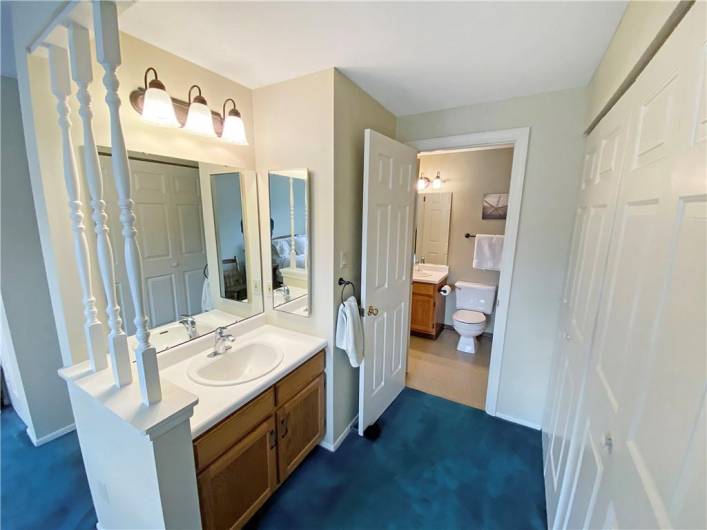 A dressing area with vanity sink connects the master bedroom and full bath.