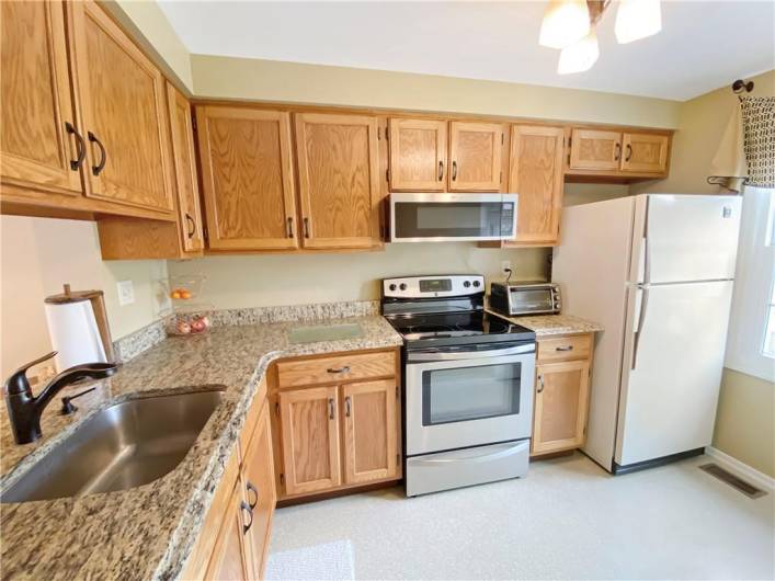 The kitchen features newer granite countertops.