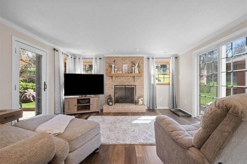 The family room addition is a cozy space to enjoy the outdoors, the warmth of a fire and still feel connected to the life unfolding in the kitchen.