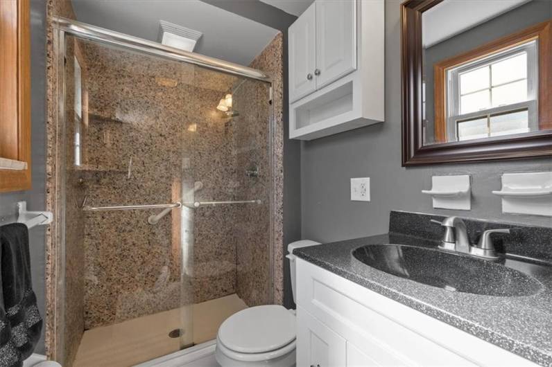 This Master bath has a granite surround stand up shower, newer vanity, lighting and fixtures.