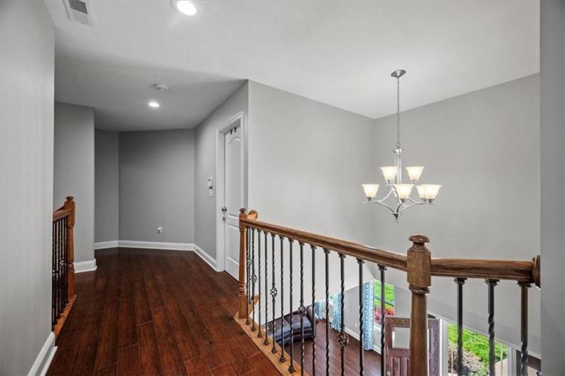 Large hallway overlooking the foyer with walk in storage closet.