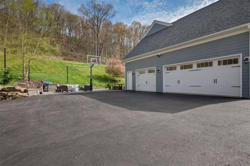 Large 3 car attached garage and turnaround area in driveway.