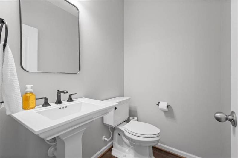 First floor powder room with upgraded fixtures.