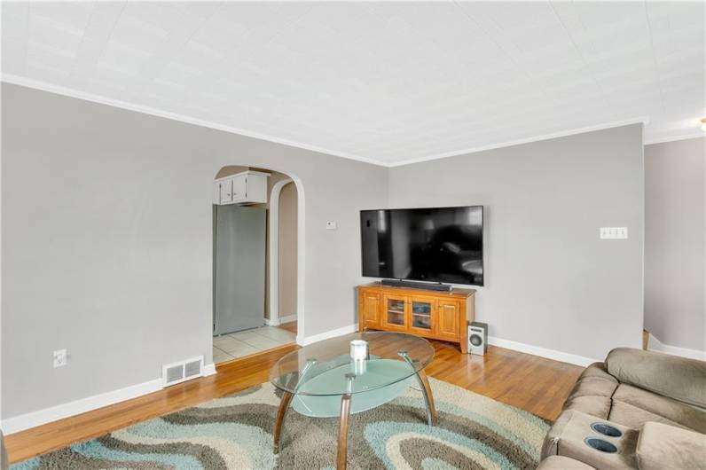 You'll love the original features throughout like these arched doorways & hardwood floors!