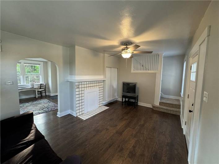 Beautiful flooring in living and dining room. Decorative fireplace accents the room.