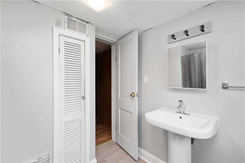 Basement Full Bath with linen closet.
