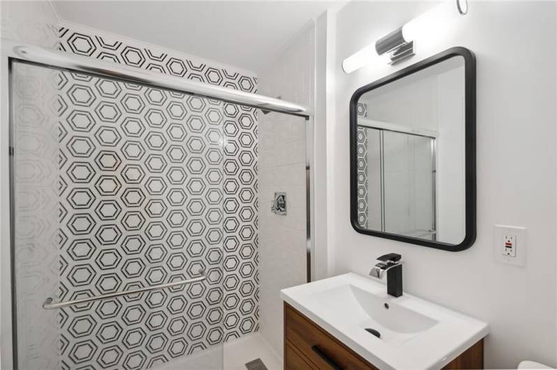 Located on the main living level, you'll find this gorgeous full bath with custom tile work.