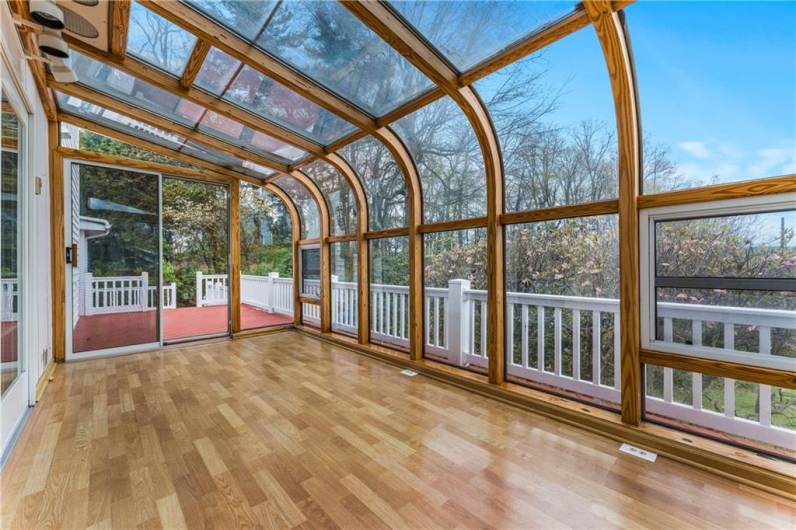 The sun room is situated on the back deck and also off the first floor primary bedroom