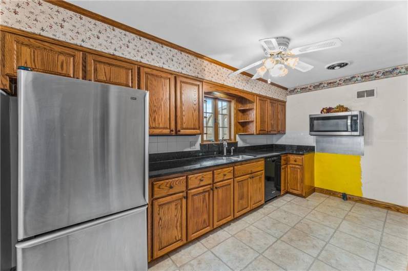 The galley kitchen has granite countertops and ample counter space for cooking/baking,  all appliances except stove are included