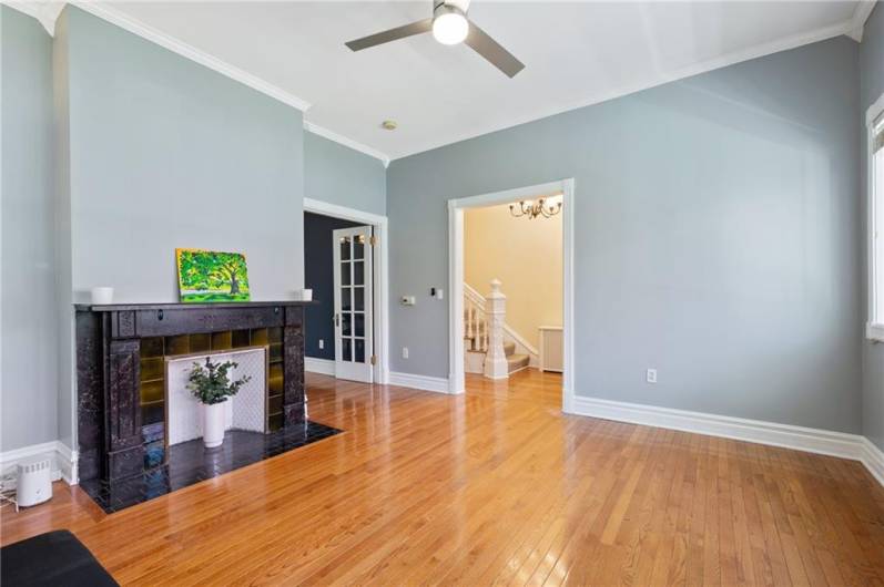 Hardwood floors and updated ceiling fan in the living room.