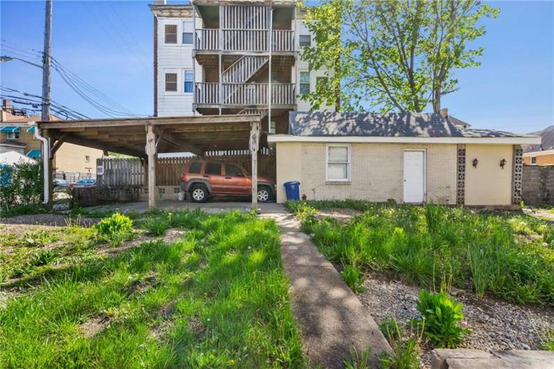 Out back you will find a detatched garage with additional storage space and a covered parking pad that should hold 4 cars.  Ample on street parking.