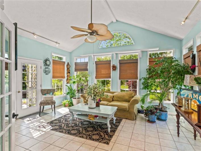 BRIGHT AND SUNNY FAMILY ROOM HAS FIREPLACE AND LEADS TO OUTSIDE PATIO AND POOL