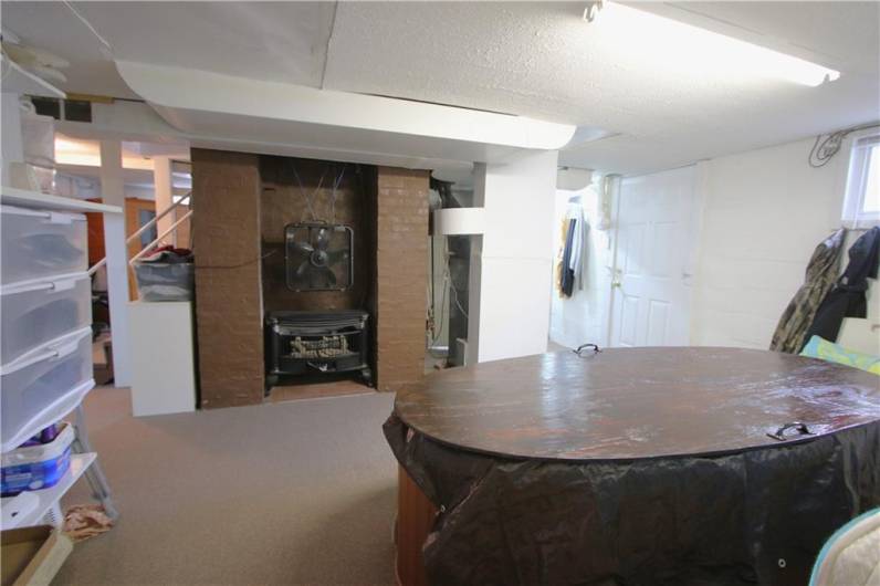 Great 15x11 Game Room w/ Hot Tub & Gas Fireplace insert. Easy access to Back Yard and Pool from Basement Door