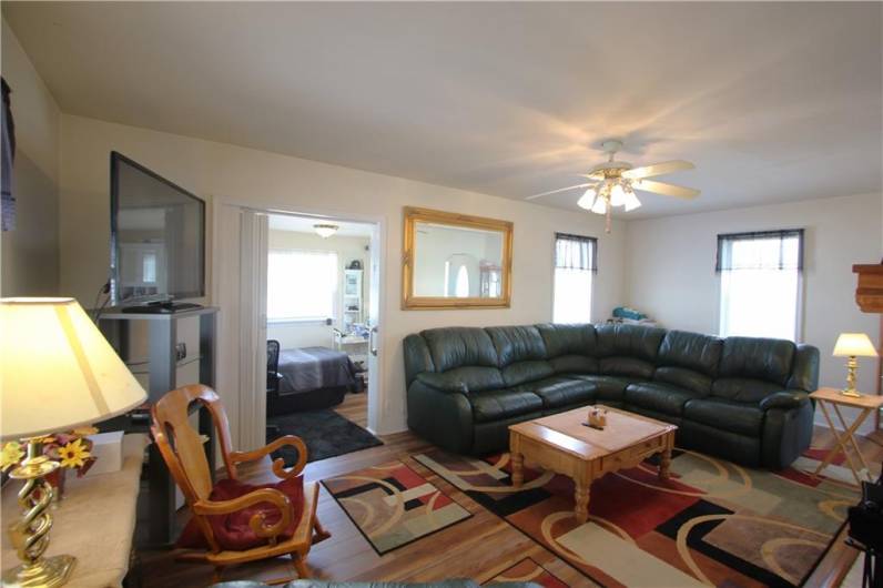 Large 21x11 Living Room w/ Ceiling Fan Light & Plenty of Windows calling in the NaturalLight.