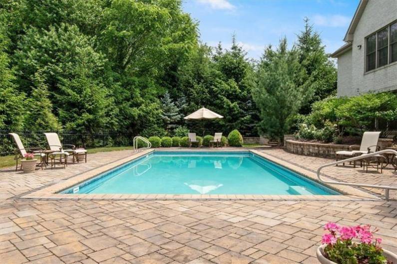 The salt-water Pool has an electric cover as well as a winter cover.  Paver hardscape surrounds the pool. Tucked away for total PRIVACY you will love spending hours and hours here.