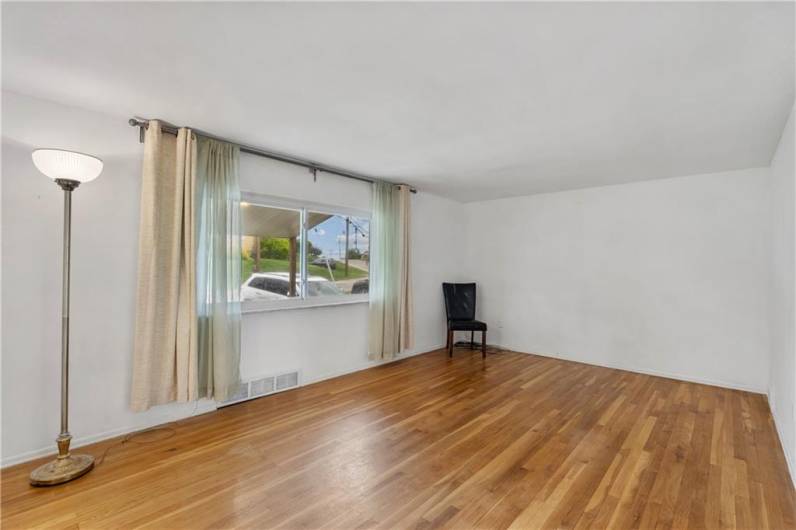 Spacious front Living Room with original hardwood floors. Freshly painted, neutral color