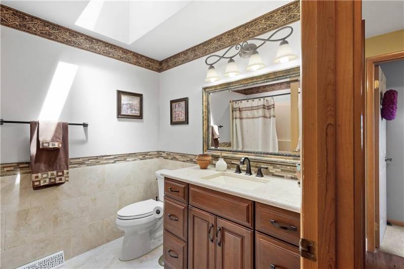 RECENTLY UPDATED HALL BATHROOM WITH SKYLIGHT.
