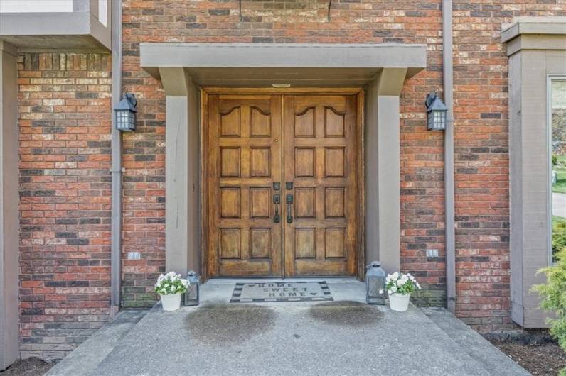 Welcoming entry with solid wood doors!