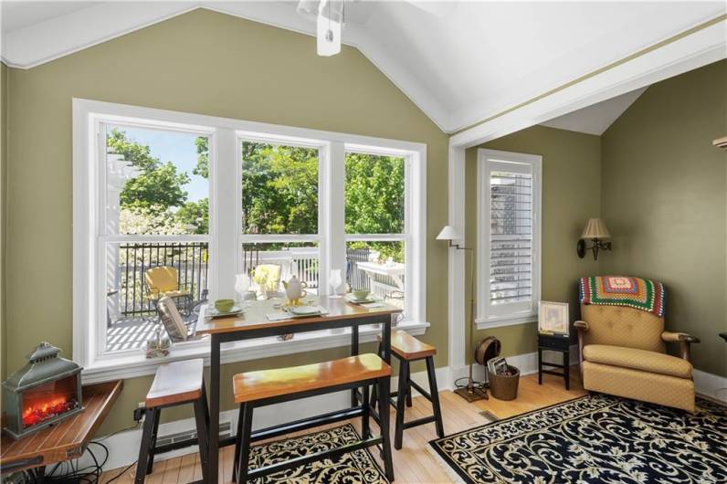 The breakfast room addition with its large triple window is adjacent to a cozy nook for relaxing with a good book.