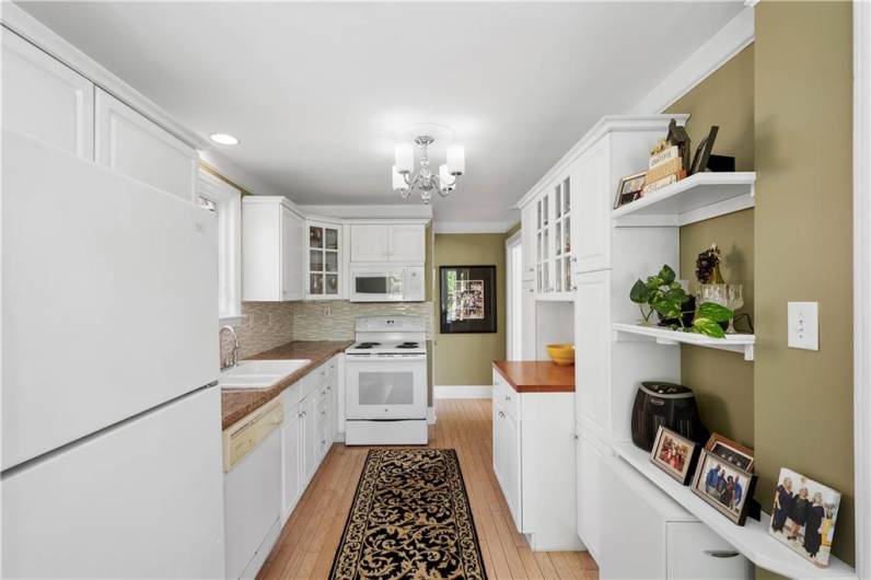 There's an abundance of counter and cabinet space with a spot for shelving and displaying.