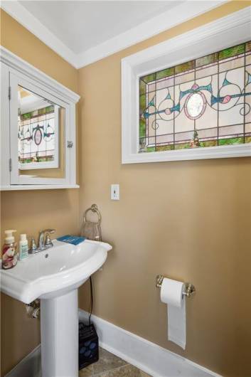 A first floor powder room is perfect for guests. Plus the beautiful stained glass is an added bonus!