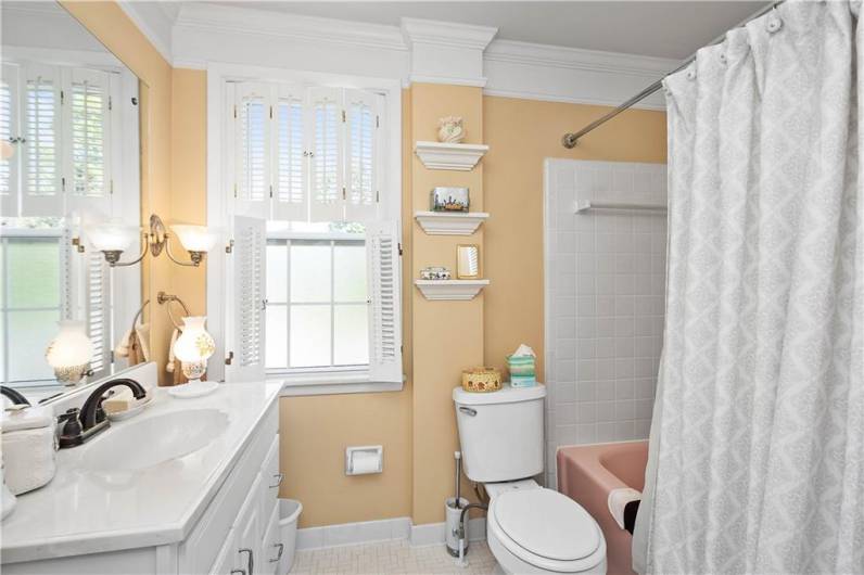 A bright and cheerful bath room on the second floor with tile floor and tub/shower.