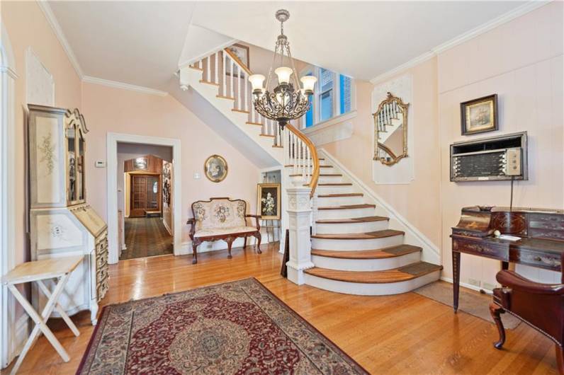 Gorgeous foyer upon entry with high ceilings and spiral staircase