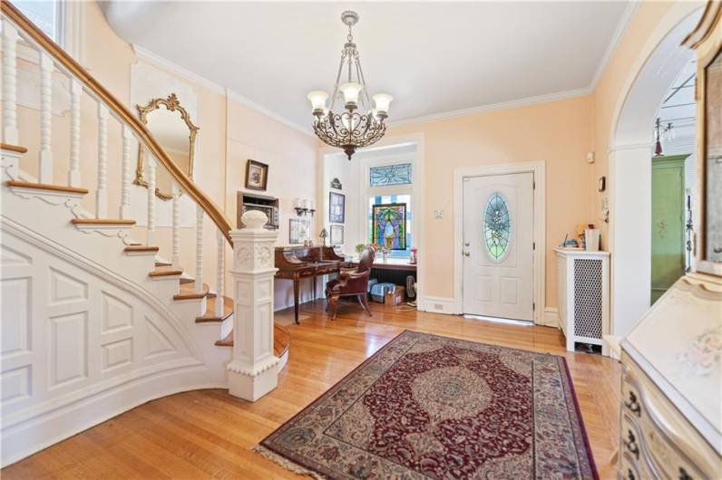 Gorgeous foyer upon entry with high ceilings and spiral staircase