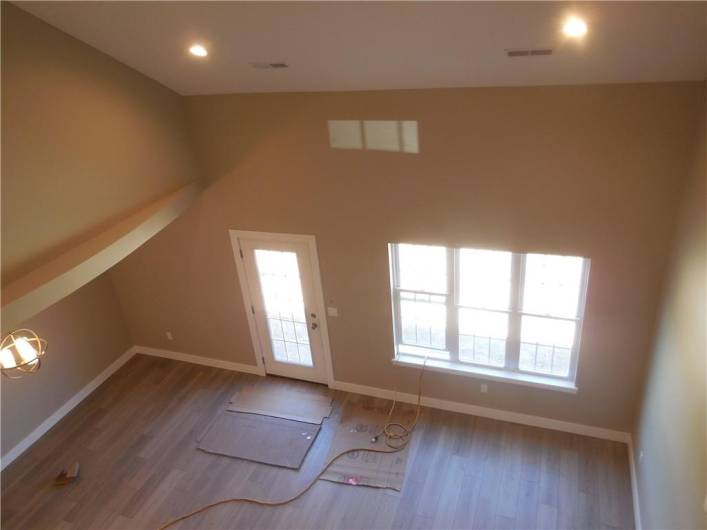 View from loft to living room and dining area and back door.