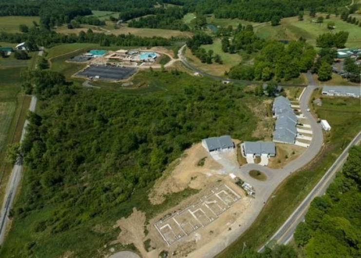 Aerial shot of Pinehurst Village next to Seven Oaks Country Club and new pool/recreational complex.