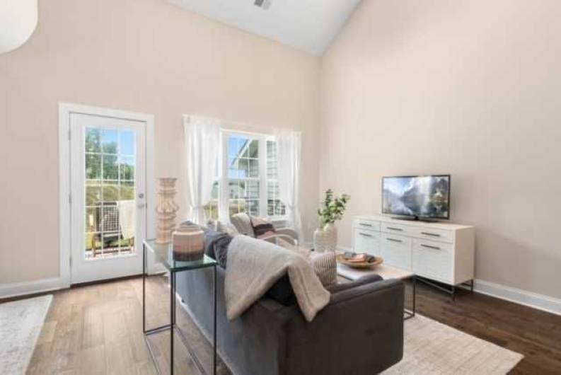 Light & bright living room with access to back patio.