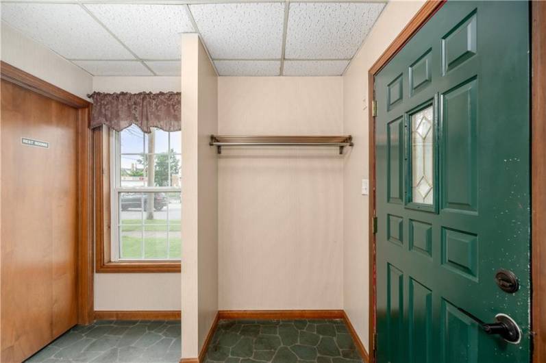 Entrance into waiting room with coat closet and bathroom