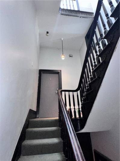 Stairwell to 3rd floor apartment entry.